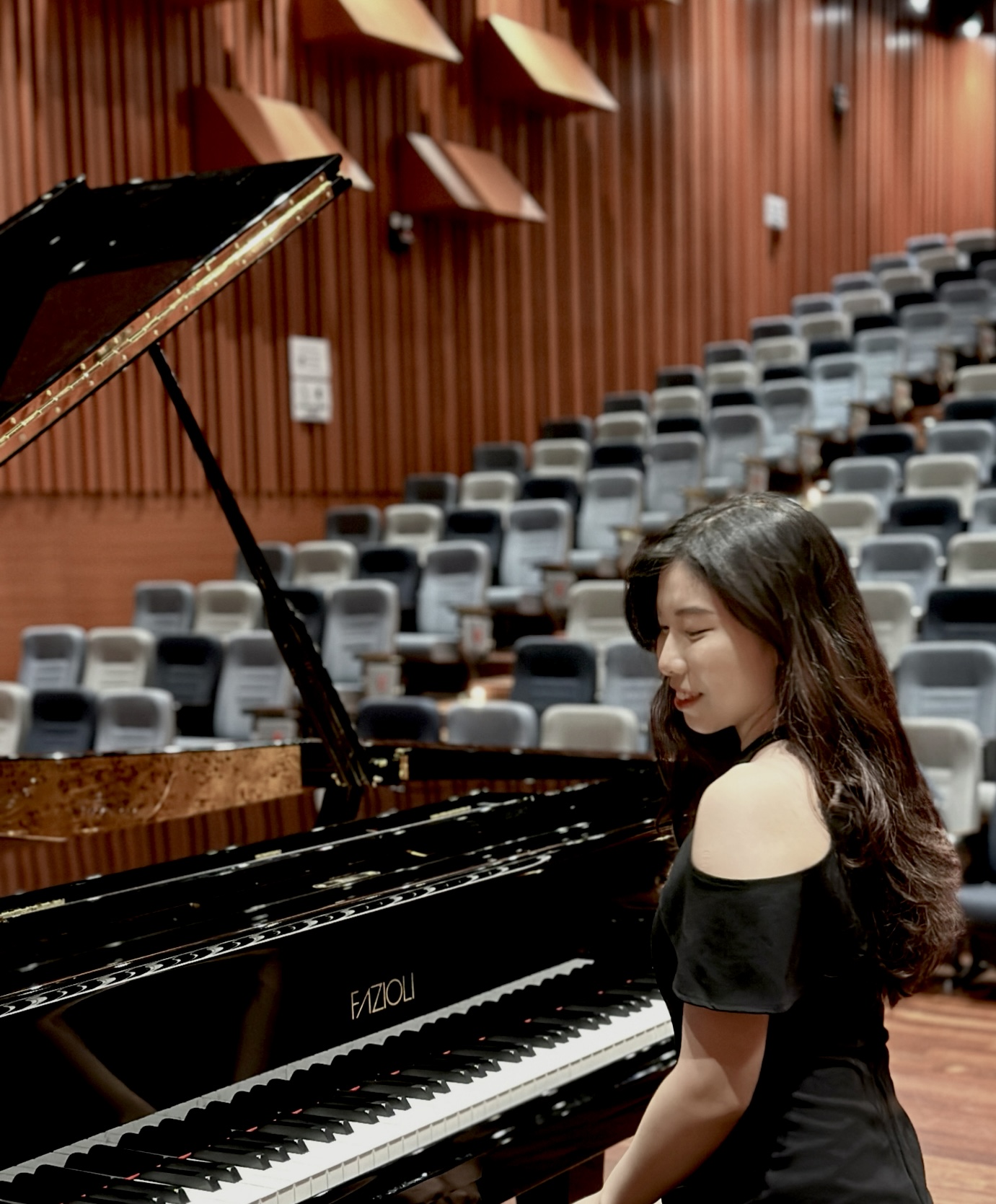 Piano teacher from Loh Piano Studio performing on stage